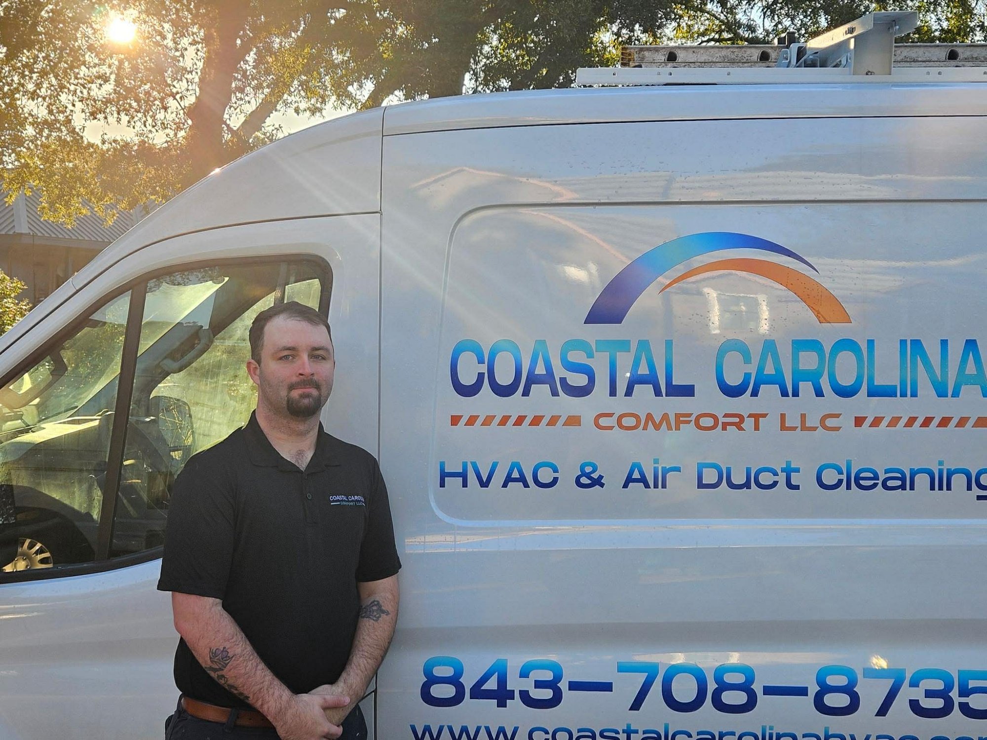 Coastal Carolina Comfort owner in front of branded HVAC service van