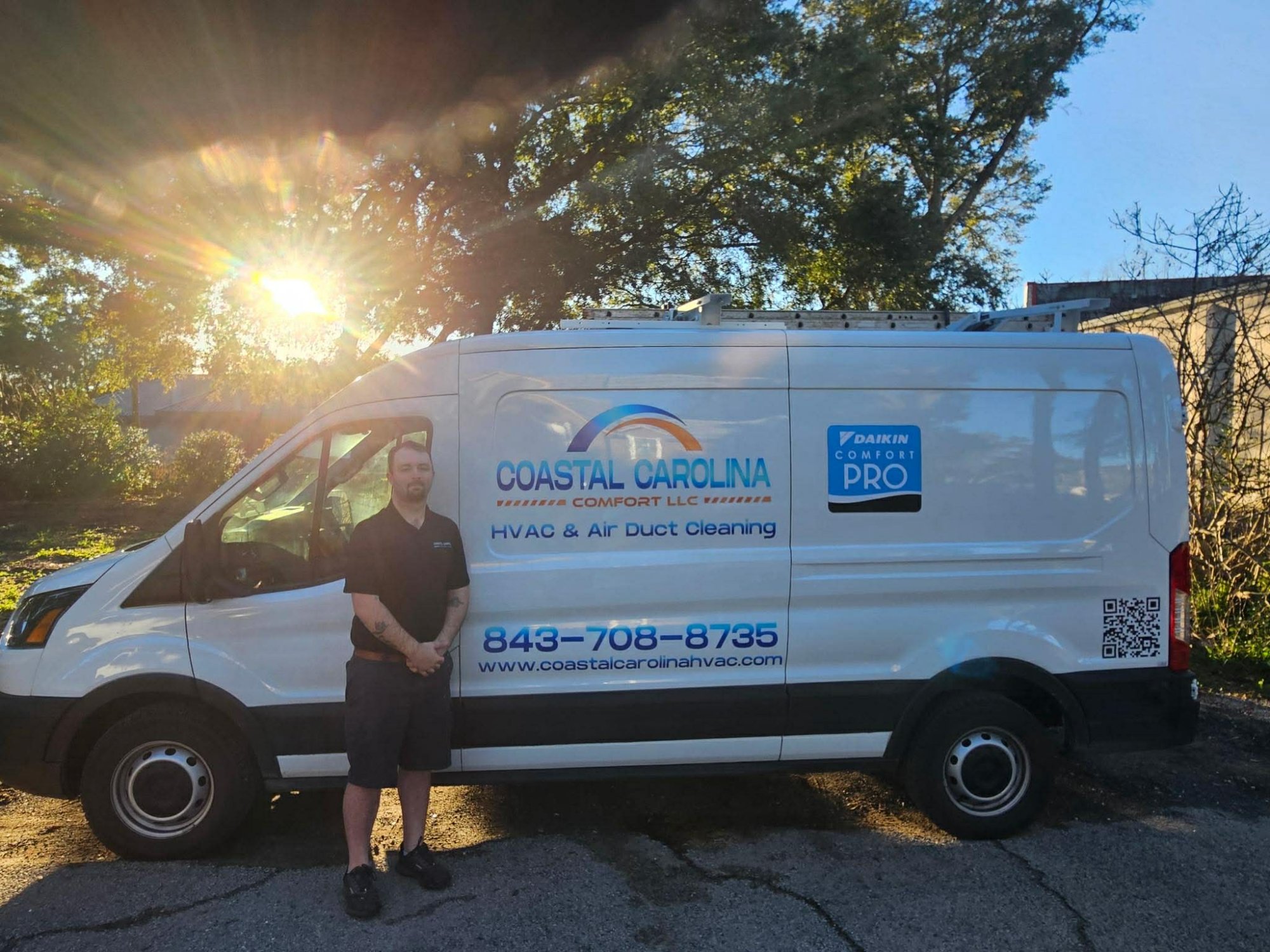 Coastal Carolina Comfort owner standing next to branded service van